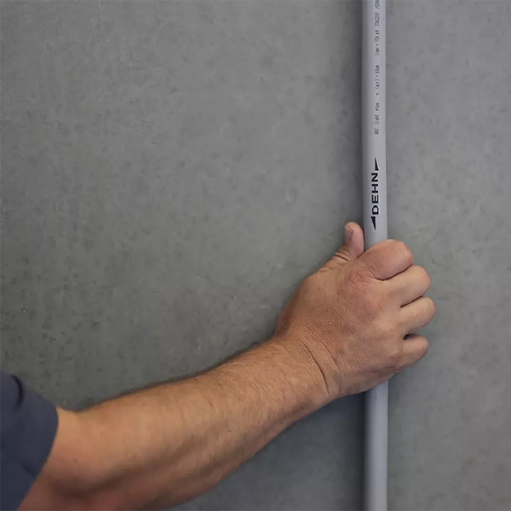 A hand holding a HVI light plus conductor